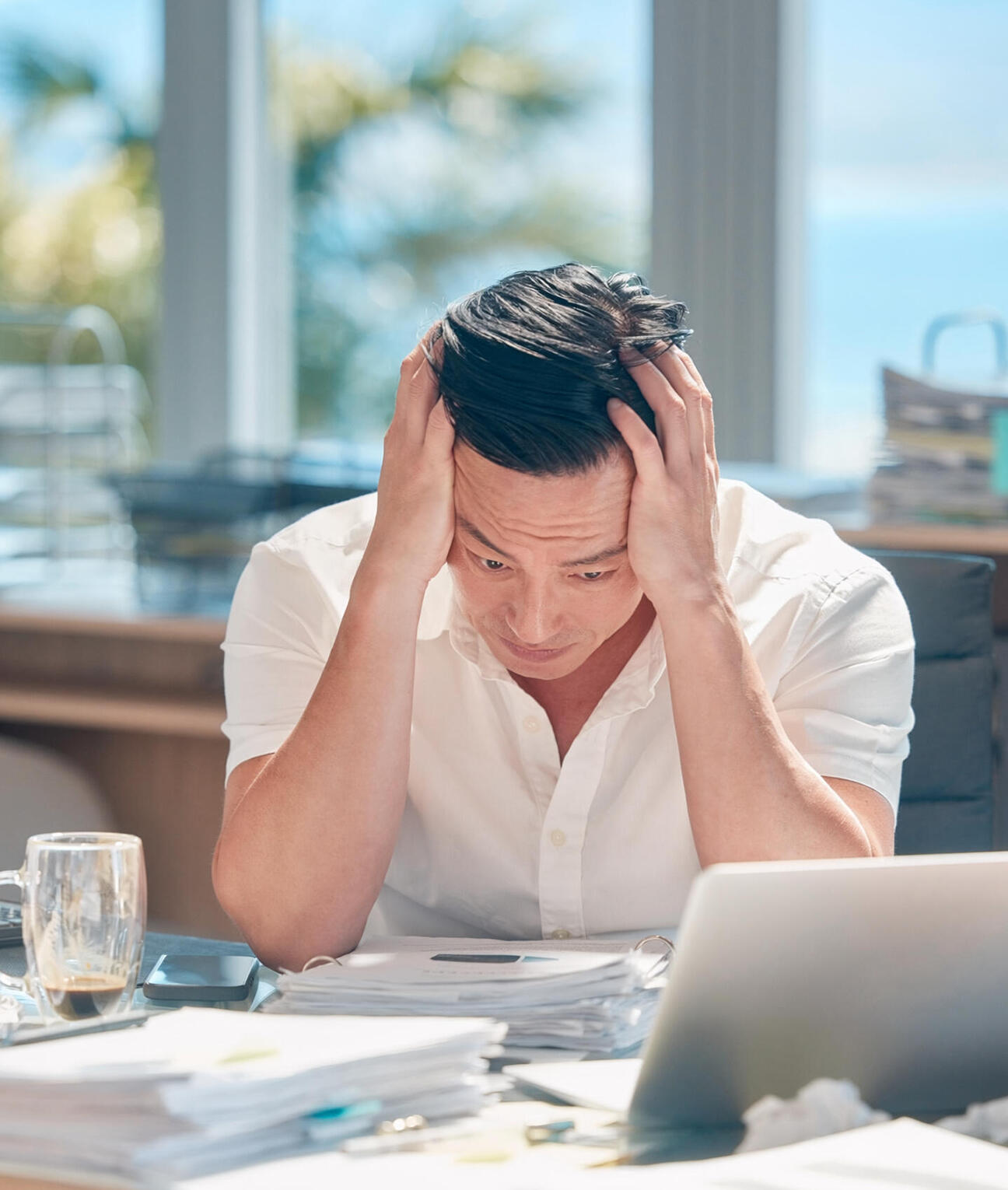 stressed executive reviewing paperwork